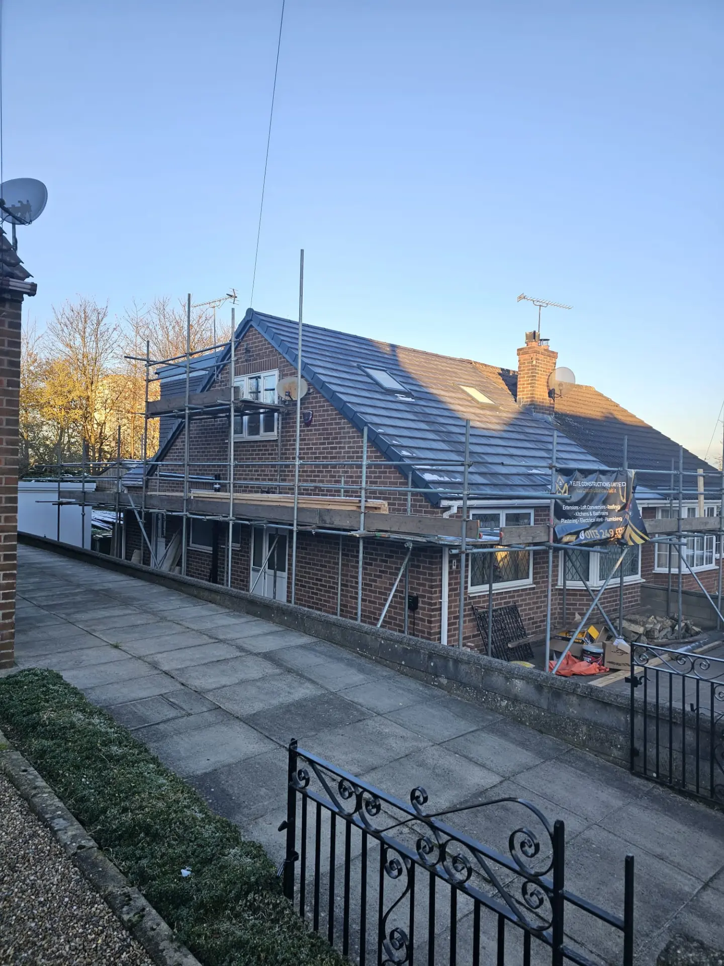 Y Elite Constructions scaffolding and branded banner on a dormer loft conversion and re-roof in Leeds