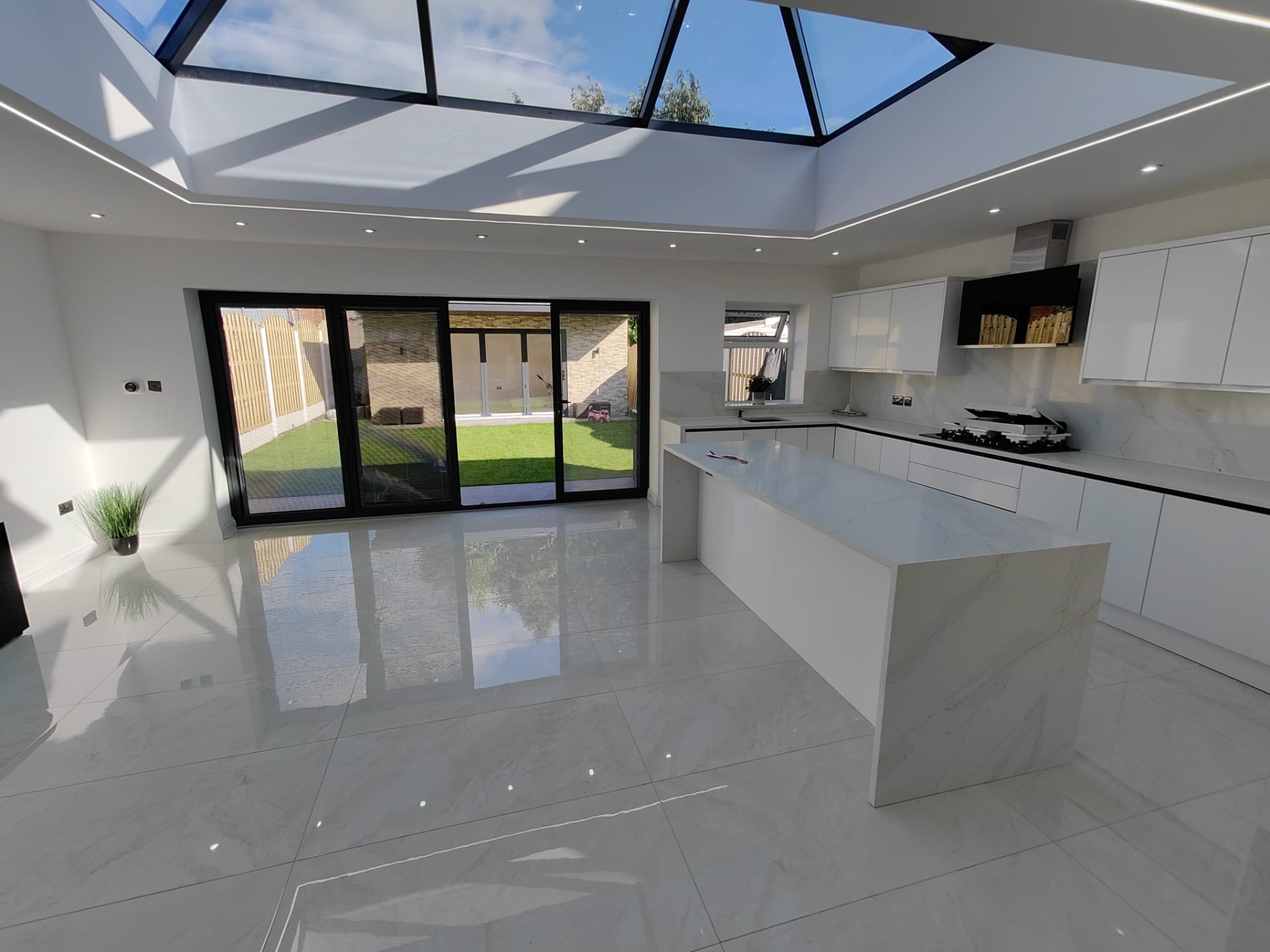 Open-plan kitchen extension in Leeds with roof lantern, marble island and bi-fold doors
